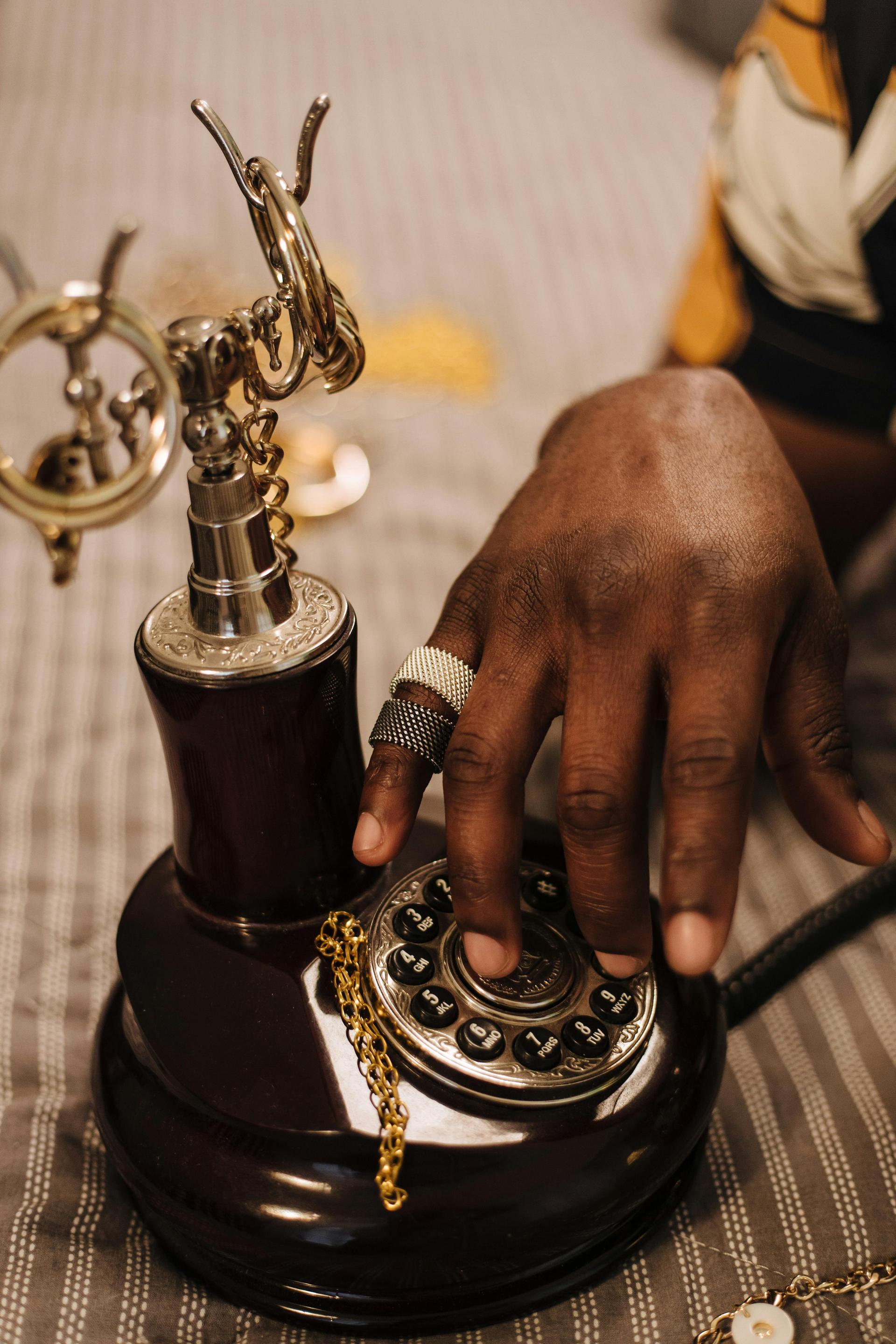 Hand on a classic rotary telephone