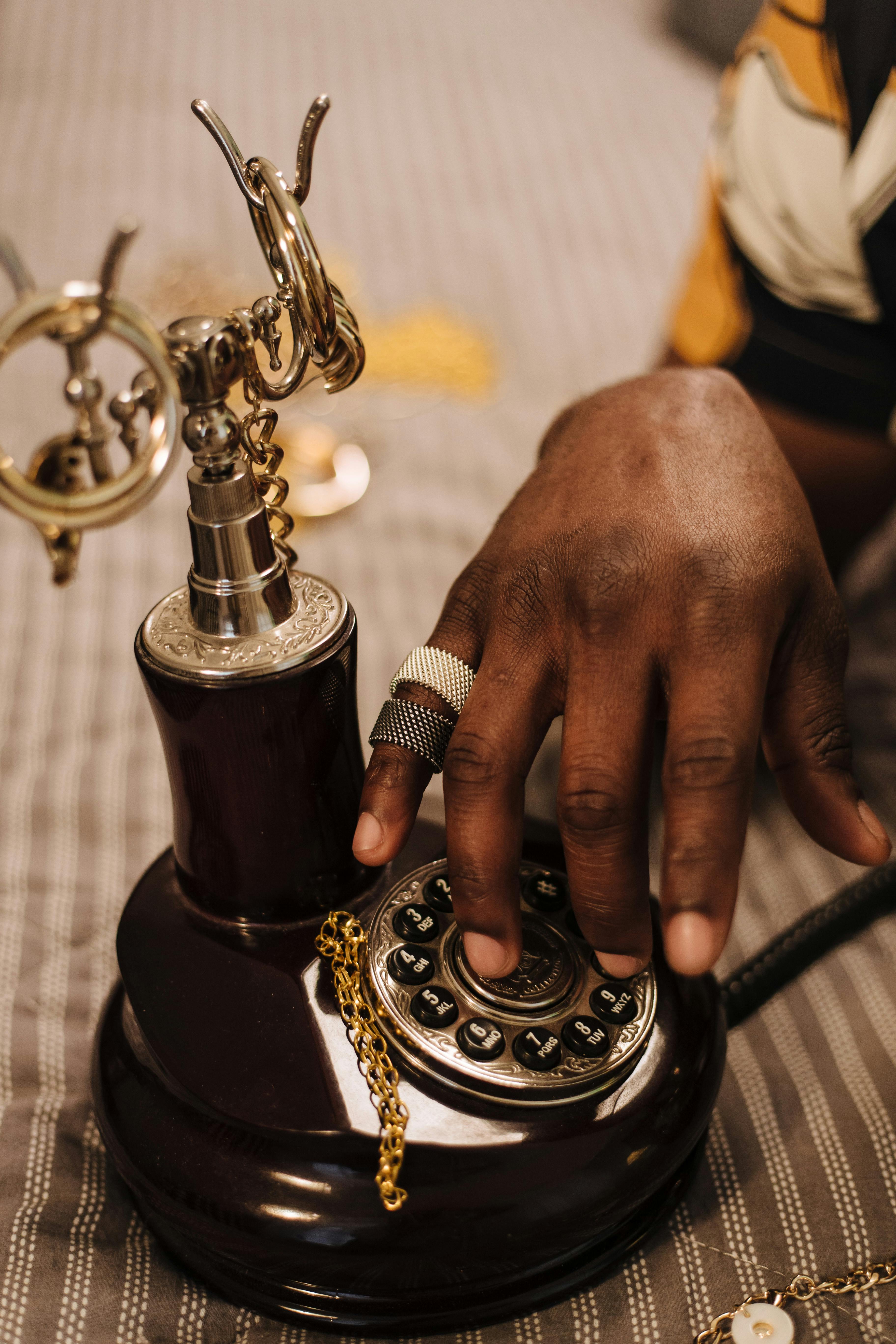 Hand on a classic rotary telephone